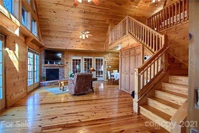 Great Room With Vaulted Ceiling and Stacked Stone Fireplace