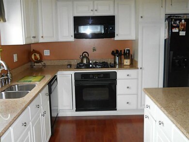 Kitchen cabinetry is elegant and pristine, cherry 
