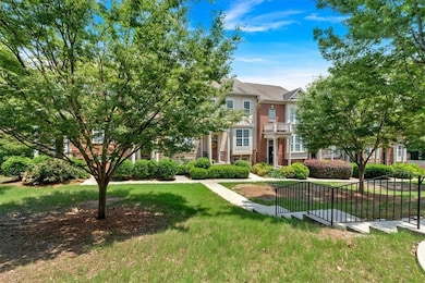 View of property featuring a front lawn and brick siding