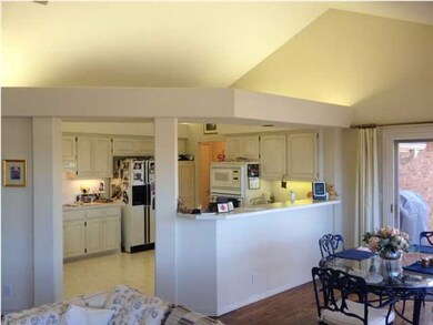 The kitchen is open to a large breakfast area, wit