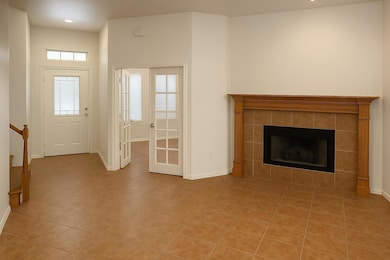 Foyer with light tile patterned flooring, a tile 