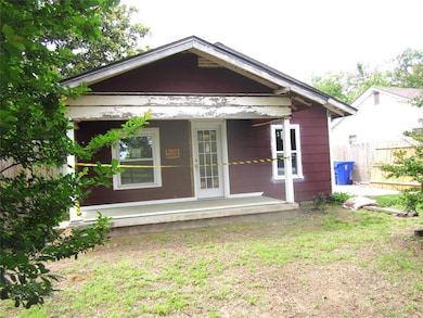 View of front of property with fence and a porch