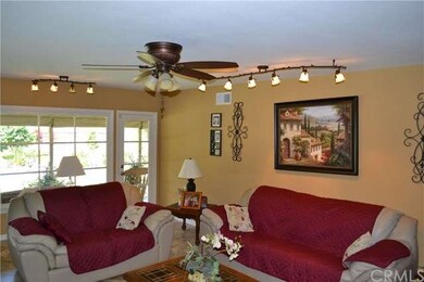 Living room with with fireplace, ceiling fan, and 