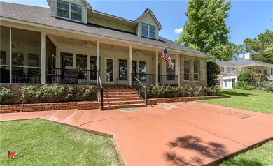 Awesome rear porch has ceiling fans, iron railings
