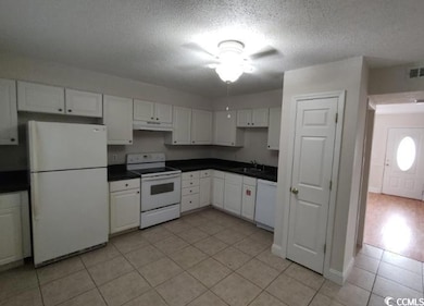 Kitchen with white appliances, under cabinet range