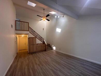 Unfurnished living room featuring baseboards, a c