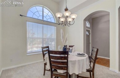 Dining space featuring a chandelier, crown molding