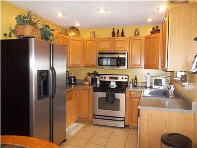 Stainless steel appliances and ceramic tile floor.