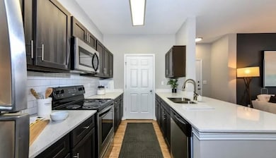 Kitchen with decorative backsplash, a peninsula, l