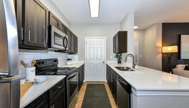 Kitchen with decorative backsplash, a peninsula, l