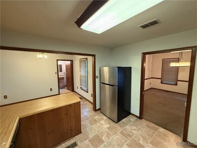 Kitchen featuring light carpet, decorative light f