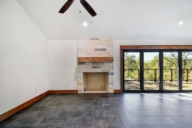 Unfurnished living room with lofted ceiling and a ceiling fan