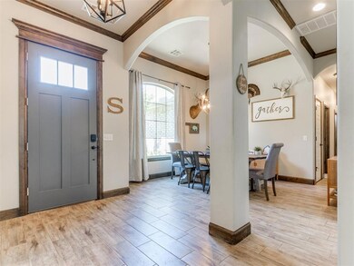 Entryway with arched walkways, plenty of natural l