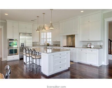 Kitchen. Everyone will want to congregate in this kitchen with a maginificent, large granite island, stainless steel appliances, double ovens and spectacular wood floors.  Storage space everywhere with a large pantry.