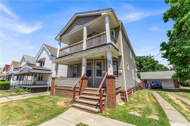 View of front of house featuring a garage, a balcony, and a front lawn