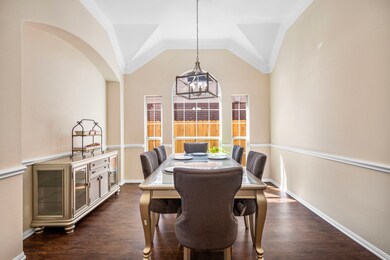 Formal dining room with beautiful natural light and soaring ceilings.
