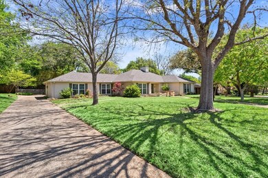 Single story home featuring concrete driveway and 
