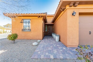 Walkway to front door also landscaped with pavers.