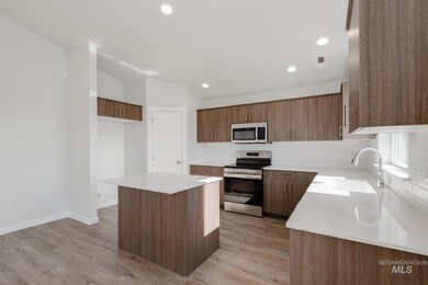 Kitchen featuring stainless steel appliances, decorative backsplash, a center island, modern cabinets, and recessed lighting