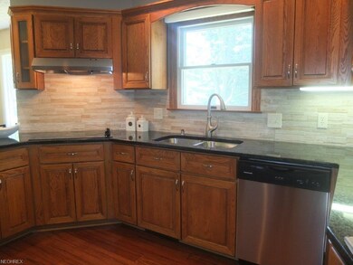 Kitchen has a countertop range, stainless steel ap