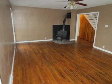 Living Room. Living room with wood stove and hardw