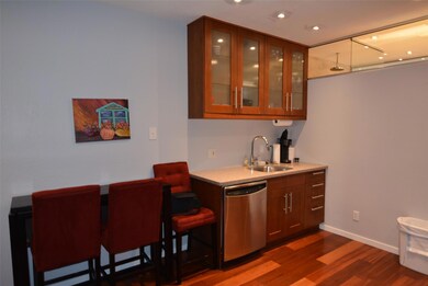 Bar with a sink, baseboards, dishwasher, recessed