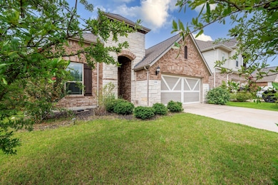 View of front of property featuring a garage, dri