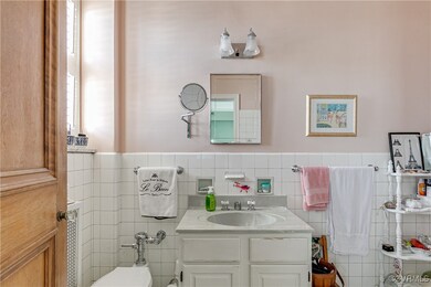 Bathroom with vanity, tile walls and  backsplash