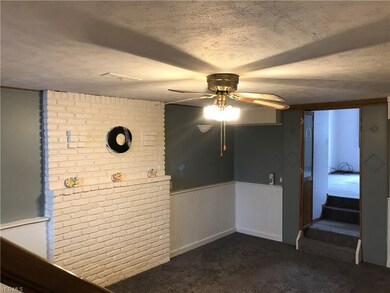 Family room, steps lead to bedroom with attached b