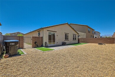 Rear view of property featuring a gate, stucco sid