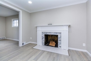 Unfurnished living room featuring wood finished floors, a fireplace, and recessed lighting