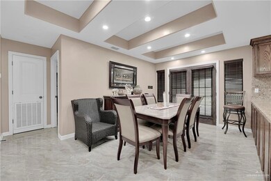 Tiled dining room with a tray ceiling