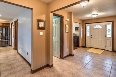 Inviting foyer has door with side lights and tile 