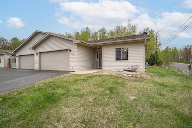 Single story home with an attached garage, asphalt