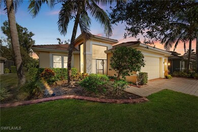 View of front of home featuring a yard and a garag