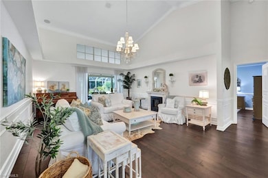 Living room featuring high vaulted ceiling, dark h