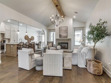 Living room featuring a notable chandelier, dark h