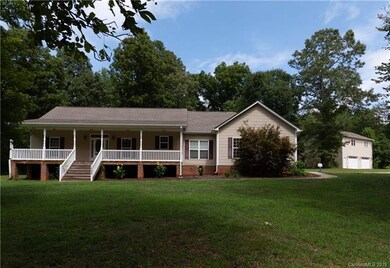 Another front exterior with many mature trees.