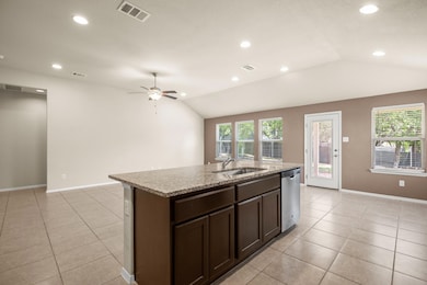 Kitchen with vaulted ceiling, light tile patterne