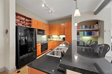 The modern kitchen boasts a sleek breakfast bar, perfect for enjoying your morning coffee or hosting intimate gatherings.