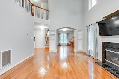Unfurnished living room featuring arched walkways,