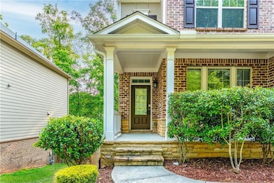 Doorway to property with brick siding and covered porch