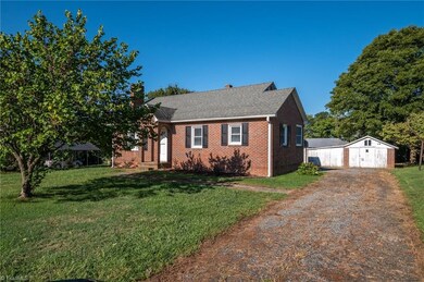 Driveway leading to home and outbuildings.