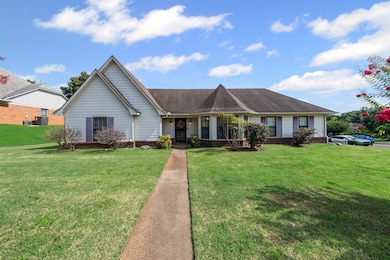 Single story home featuring a front lawn, brick siding, covered porch, and roof with shingles
