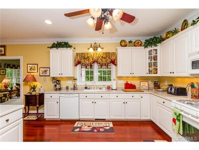 Spacious Open Kitchen, Crown Molding, Custom White Cabinetry, Corian Counter-tops, Gas Cooking, Wood Flooring