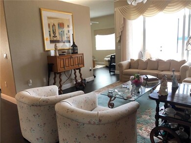Living room with family room shown in back.