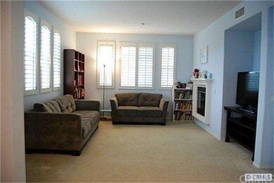 Family room with plantation shutters and fireplace