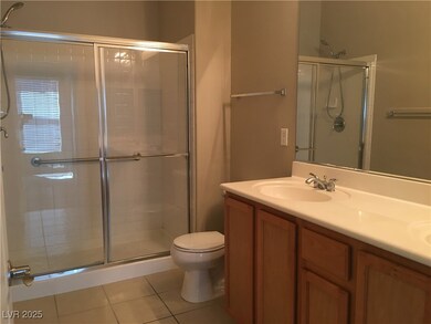 Bathroom featuring a shower stall, tile patterned