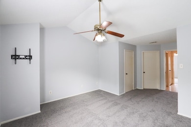 Empty room with baseboards, a ceiling fan, carpet 