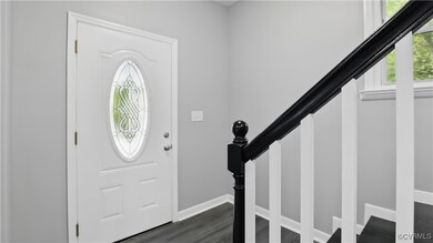 Entryway with baseboards, dark wood finished floor